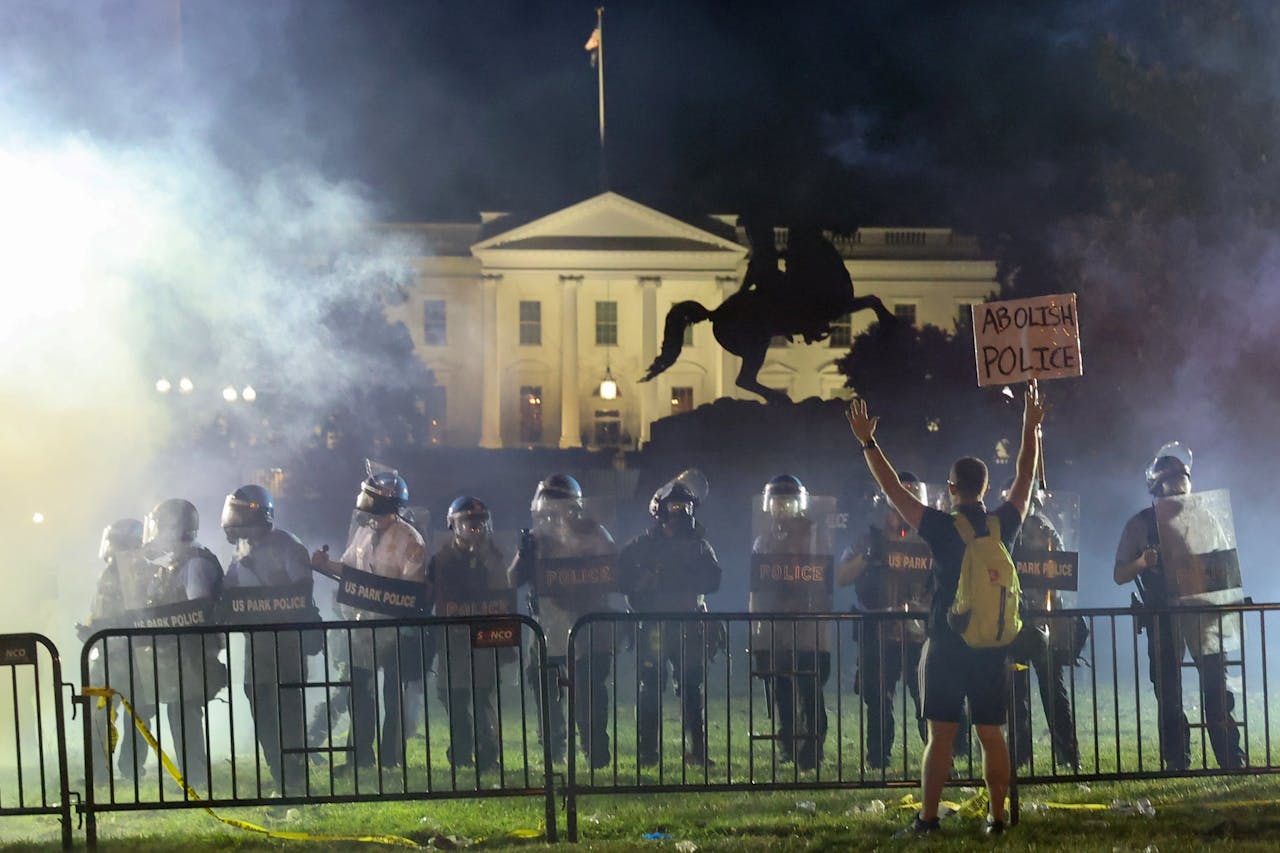 Politie in rellenuitrusting houden protestdeelnemers op afstand van het Witte Huis in Lafayette Park in Washington.